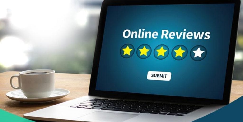 laptop screen showing the words online review with 5 yellow stars underneath it and a white submit button under than with blue background